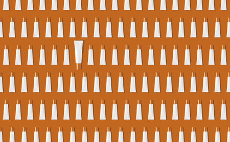 Creative seamless pattern of white cosmetic tubes on orange background. Cosmetics, skin care, beauty, body treatment concept. Creative design in flat lay style. Top view. Mock-up.の写真素材