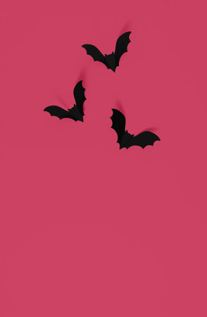 Cartoon halloween background black bats on orange backdrop. Bright holiday backdrop for your design in flat lay style with copy space.の写真素材