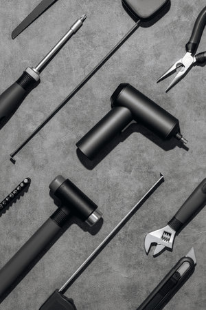 Flat lay composition with set of home repair tools on grey stone background. Top view pattern with copy space.の写真素材