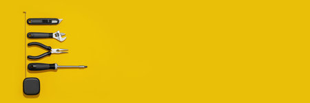 Flat lay composition with set of home repair tools on bright yellow background. Top view pattern...