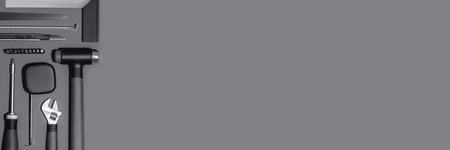 Flat lay composition with set of home repair tools on dark grey background. Top view pattern with...