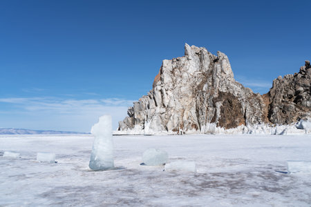 Beautiful winter landscape with blue ice cave grotto and frozen clear icicles. Lake Baikal, Russia. Natural winter background with copy space.の写真素材