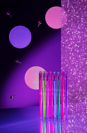 Creative minimal composition made with school supplies flying in the air in neon colors with copy...