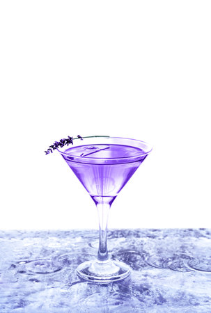 Modern transparent cocktail adorned with lavender standing on ice bar. Isolated white background.の写真素材