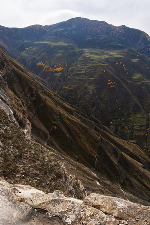 Mesmerizing vista of a steep cliff, ravine, and emerald green terraces. Natural background.の写真素材