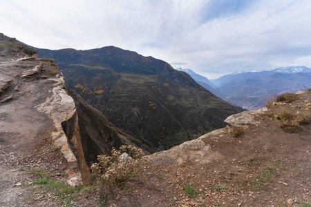 Extensive outlook of a canyon, vibrant green terraced landscapes and snowy mountain crests. Natural background.の写真素材