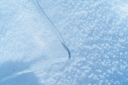 Ice hummocks covered in snow on Baikal Lake. Transparent blue ice floe. Natural background. Great...