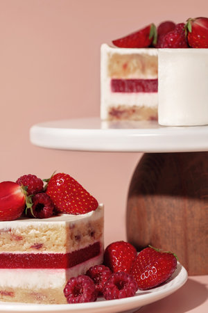 Bento cake with layers of fluffy vanilla sponge, raspberry, and strawberry, beautifully displayed on...
