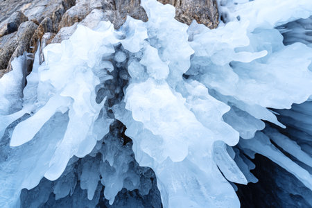 Ice formations emerging from rocky surface create a captivating natural backdrop, showing intricate...