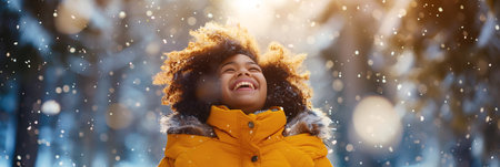 Joyful girl wearing a bright yellow winter jacket stands in a snowy landscape, smiling as snowflakes fall around her, creating a cheerful atmosphere with ample copy space for design purposesの素材