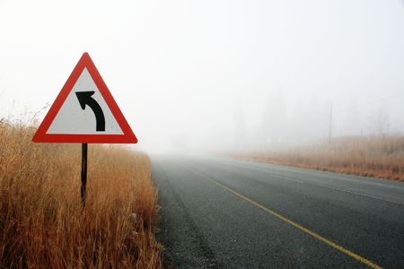 Road curvinbg into the unknown with very poor visibilityの写真素材
