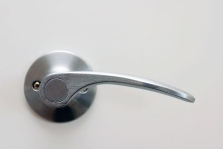 A door knob on white door.の写真素材