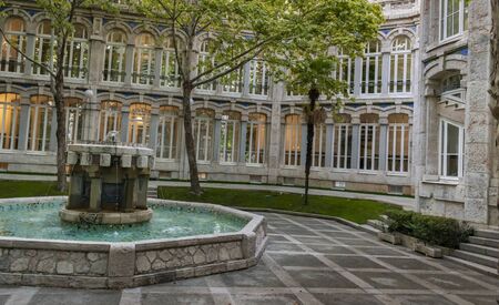 Beautiful interior patio with blue water fountainの写真素材