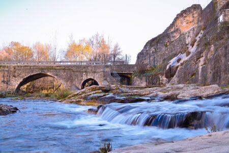 Long exposition. Water flowing under a bridge