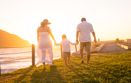 Family holding hands walking togetherの写真素材