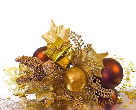 Christmas ornament - golden branch with baubles, gift box, leaves and other decorationsの写真素材