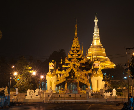 Burmese famous sacred place and tourist attraction landmark - Shwedagon Paya pagoda illuminated in the evening, Yangon, Myanmar (Burma).の写真素材
