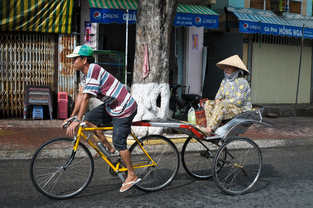 CHAU DOC, VIETNAM - SEP 20, 2014. Trishaw on street in Chau Doc town, Vietnam. Trishaws have been around for more than a century in Mekong Delta.のeditorial素材