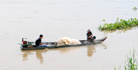 Mekong Delta, Vietnam - May 25, 2014. Asian people sitting on canoe and rowing. Traditional Asian boat made of wood.のeditorial素材