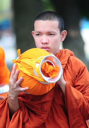 AN GIANG, VIETNAM - FEB 26 2015. Unidentified young monks walking morning alms in An Giang, Vietnam. Theravada Buddhism arrived from India into the southern Vietnam between 300-600 AD.のeditorial素材