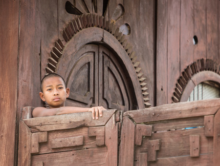 MANDALAY, MYANMAR - DECEMBER 8, 2014. An unidentified Burmese Buddhist novice in Mandalay, Myanmar. In 2012 an ongoing conflict started between Buddhists and Muslims in Myanmar.のeditorial素材