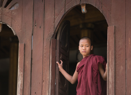 MANDALAY, MYANMAR - DECEMBER 8, 2014. An unidentified Burmese Buddhist novice in Mandalay, Myanmar. In 2012 an ongoing conflict started between Buddhists and Muslims in Myanmar.のeditorial素材