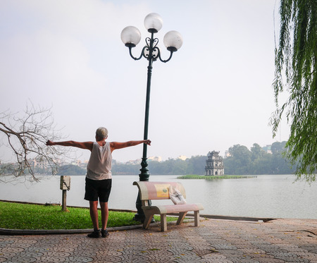 Hanoi, Vietnam - Nov 16, 2014. Life in Vietnam - Man doing the exercise near Hoan Kiem lake, Hanoi, Vietnam.のeditorial素材