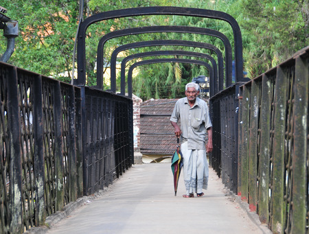 COLOMBO, SRI LANKA - MAY 2, 2014. An unidentified man walking and relaxing at the park in Colombo. Colombo is the largest city with population about 1 million people.のeditorial素材