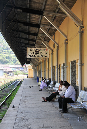 BENTOTA, SRI LANKA - APR 28, 2015. People wait for a train on railway platform in Bentota, Sri Lanka. Trains are becoming more popular transport last years due to railway improvement by government.のeditorial素材