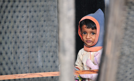KANDY, SRI LANKA - JULY 18, 2014. A young girl poses for a photo in deprived areas of Kandy, Sri Lanka. There are about 60% of people of the city live in slums.のeditorial素材