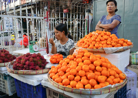 Yangon, Myanmar - Jan 14, 2015. Burmese women selling fresh fruits at Bogyoke market in Yangon, Myanmar.のeditorial素材