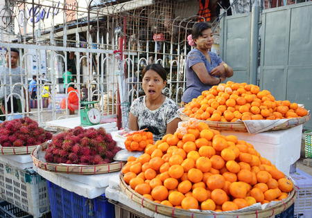 Yangon, Myanmar - Jan 14, 2015. Burmese women selling fresh fruits at Bogyoke market in Yangon, Myanmar.のeditorial素材