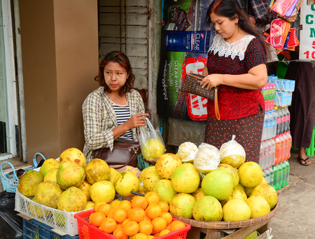 Yangon, Myanmar - Jan 14, 2015. Burmese women selling fresh fruits at Bogyoke market in Yangon, Myanmar.のeditorial素材
