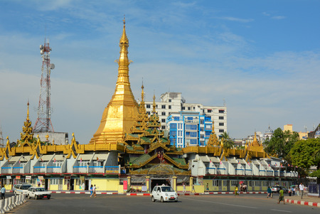 YANGON, MYANMAR - JAN 15, 2015. People and vehicles in downtown Yangon, Myanmar. In the middle of a roundabout, Yangon City Hall and Sule Pagoda located in the heart of Yangon.のeditorial素材