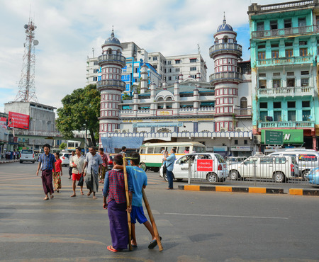 YANGON, MYANMAR - JANUARY 15, 2015. Unidentified people walk in the street in Yangon, Myanmar. Yangon is the largest city and the most important commercial centre in Myanmar.のeditorial素材