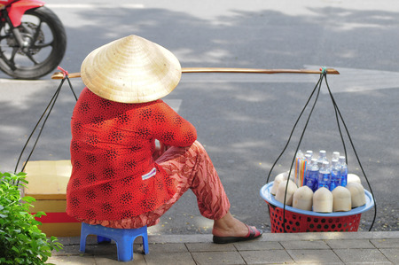 HO CHI MINH CITY, VIETNAM - JUNE 2, 2015. Unidentified street vendor selling coconuts in Ho Chi Minh City, Vietnam. Vietnam produces over 1 million tons of coconuts per year.のeditorial素材