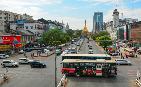 Yangon, Myanmar - April 6, 2015. View from a pedestrian overpass on Sule Pagoda Road of traffic, people, and buildings in downtown Yangon. The historic Sule Pagoda is at the end of the street.のeditorial素材
