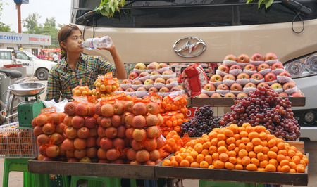 Yangon, Myanmar - Jan 14, 2015. Burmese women selling fresh fruits at Bogyoke market in Yangon, Myanmar.のeditorial素材