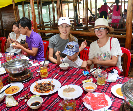 Ha Long Vietnam  June 23 2015. Group of unidentified people at a wooden restaurant having dinner in Ha Long bay Vietnam.のeditorial素材