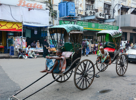 KOLKATA, INDIA - JUL 8, 2015. Rickshaw driver working in Kolkata, India. Rickshaws have been around...