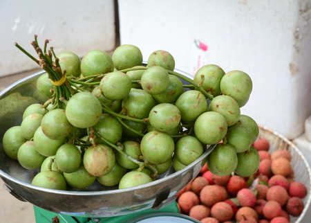 Bunch of Burmese grape (Baccaurea ramiflora) at the market in Mekong Delta, southern Vietnam.のeditorial素材