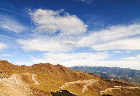 Mountain landscape with white sutra streamer scattered on the ground. Taken on the road between...