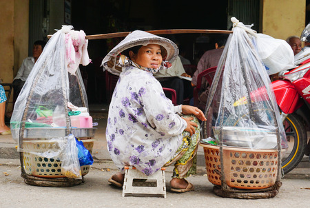 HO CHI MINH CITY, VIETNAM - JAN 29, 2015. Vietnamese woman street vendors in Saigon downtown. In Viet Nam, eating street food is a local way of life.のeditorial素材