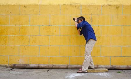 Chau Doc, Vietnam - Jul 22, 2015. An unidentified man taking images at the temple in Chau Doc town, Mekong Delta, Vietnam.のeditorial素材