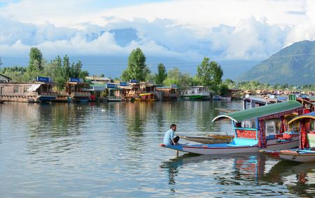SRINAGAR, INDIA - JUL 21, 2015. Lifestyle in Dal lake, local people use 'Shikara', a small boat for transportation in the lake of Srinagar, Jammu and Kashmir state, India.のeditorial素材