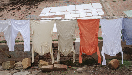 Traditional clothing dried in the sun at Ganges riverbank, Varanasi, India.の写真素材
