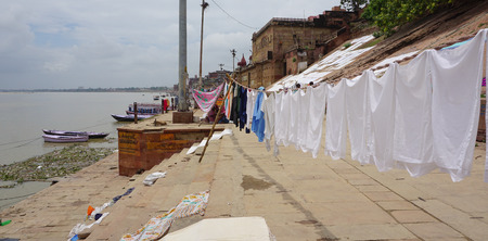 Varanasi, India - Jul 12, 2015. Local people doing their daily activities by the River Ganga at the Assi Ghat, including drying their clothes. Ghats of Varanasi serves many purposes.のeditorial素材