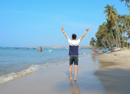 Man seen from behind, looking seaward or ocean. のeditorial素材