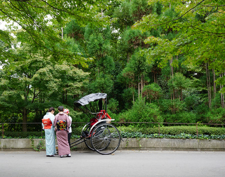 KYOTO, JAPAN - APR 8, 2015. Tourists ride rickshaw service at Arashiyama. It is a district on the western outskirts of Kyoto, Japan. It's also refers to the mountain across the Oi River.のeditorial素材
