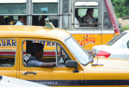 KOLKATA, INDIA -  AUG 2, 2015. Taxi driver in the car. The classical ambassador cab is the unique style of taxi service that imported from British civilization in Kolkata, India.のeditorial素材